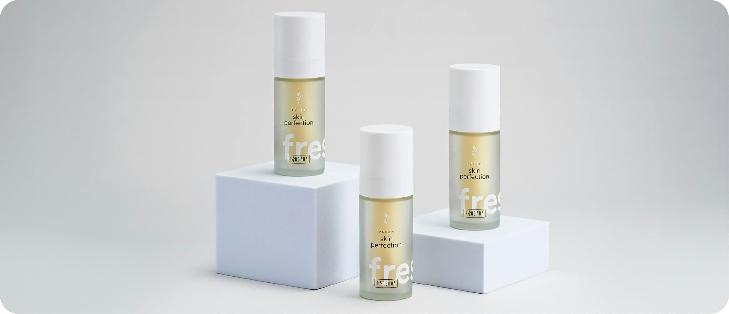 Three bottles of Ringana FRESH skin perfection on white pedestals